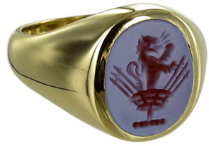Example of a red sardonyx gemstone signet ring, seal engraved with a family crest.